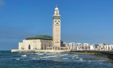 10 Days Morocco Tour,Casablanca – Hassan II Mosque: “Hassan II Mosque in Casablanca, Morocco, on a sunny day, showcasing its intricate architecture and oceanfront location.” Chefchaouen – Blue City: “Scenic streets of Chefchaouen, Morocco, painted in vibrant shades of blue with traditional Moroccan architecture.” Meknes & Volubilis: “Ancient Roman ruins of Volubilis near Meknes, Morocco, with historic columns and archaeological site views.” Ziz Valley: “Lush Ziz Valley in Morocco, with palm trees, desert landscapes, and winding river views.” Merzouga Desert: “Golden sand dunes of Merzouga in the Sahara Desert, Morocco, with camel caravans at sunset.” Sahara Desert Camp: “Traditional desert camp in Merzouga, Morocco, under a starry night sky in the Sahara Desert.” Todra Gorge: “Dramatic cliffs and narrow canyon of Todra Gorge in Morocco, ideal for hiking and adventure.” Dades Valley: “Rocky landscapes and winding roads of Dades Valley, Morocco, surrounded by towering cliffs.” Ait Benhaddou: “UNESCO World Heritage site Ait Benhaddou in Morocco, historic ksar with earthen clay architecture.” Marrakech – Jemaa el-Fnaa: “Vibrant Jemaa el-Fnaa square in Marrakech, Morocco, filled with market stalls, locals, and tourists.”