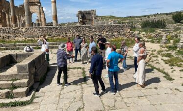 17 Days Morocco Tour From Casablanca ,The stunning Hassan II Mosque in Casablanca, Morocco, with its intricate architecture and towering minaret overlooking the Atlantic Ocean,A narrow street in Chefchaouen, Morocco, lined with blue-painted buildings and flower-filled balconies in the city's famous medina,A camel caravan crossing the vast sand dunes of Erg Chebbi in the Sahara Desert during sunset, with a golden sky in the background,he ancient fortified village of Ait Benhaddou, a UNESCO World Heritage site, with its mud-brick kasbahs and dramatic desert backdrop,The bustling Jemaa el-Fnaa square in Marrakech, filled with street performers, food vendors, and crowds of people during the day