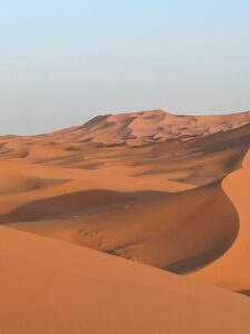 marrakech tours . Luxury Morocco desert tours and cultural experiences.,Camel caravan trekking across the golden sand dunes of the Sahara desert at sunset..A private 4x4 vehicle on a secluded sand dune, preparing for a personalized desert adventure.